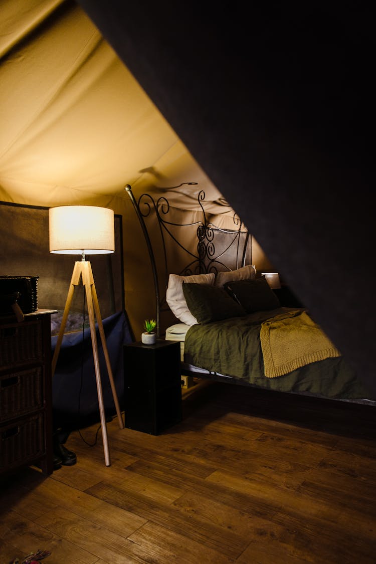 Interior Of Cozy Tent With Comfortable Bed And Lamp