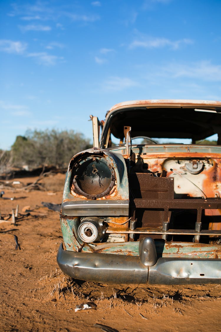 Abandoned Old Car On Sandy Ground