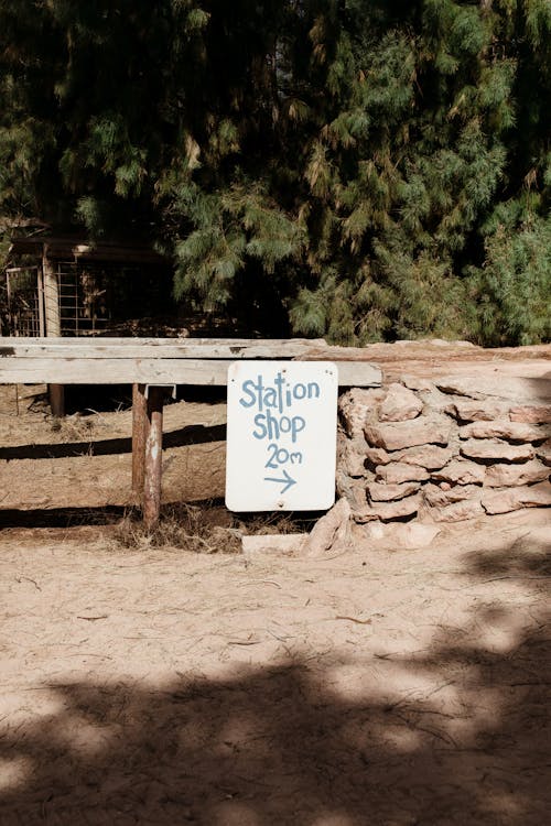 Sign hanging on wooden fence in countryside