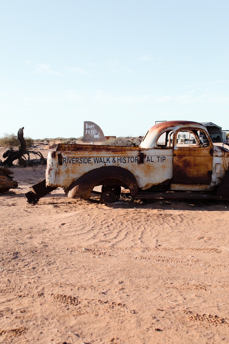 Old Rusty Car In Desert Land