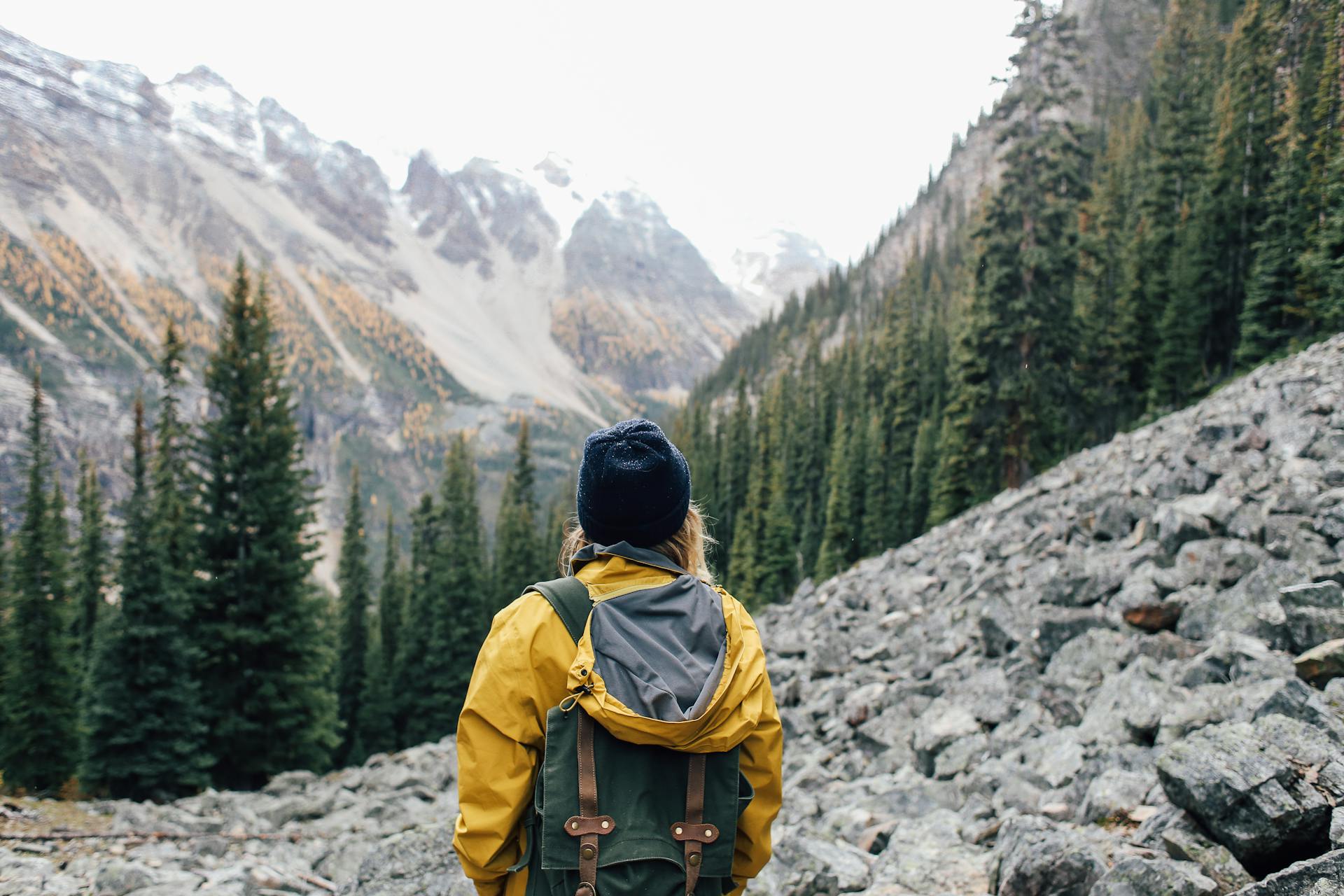 Traveler standing on stones in mountainous terrain