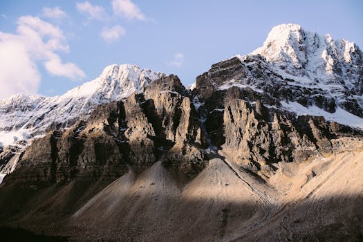 A breathtaking view of a snow-covered mountain range under a clear blue sky.