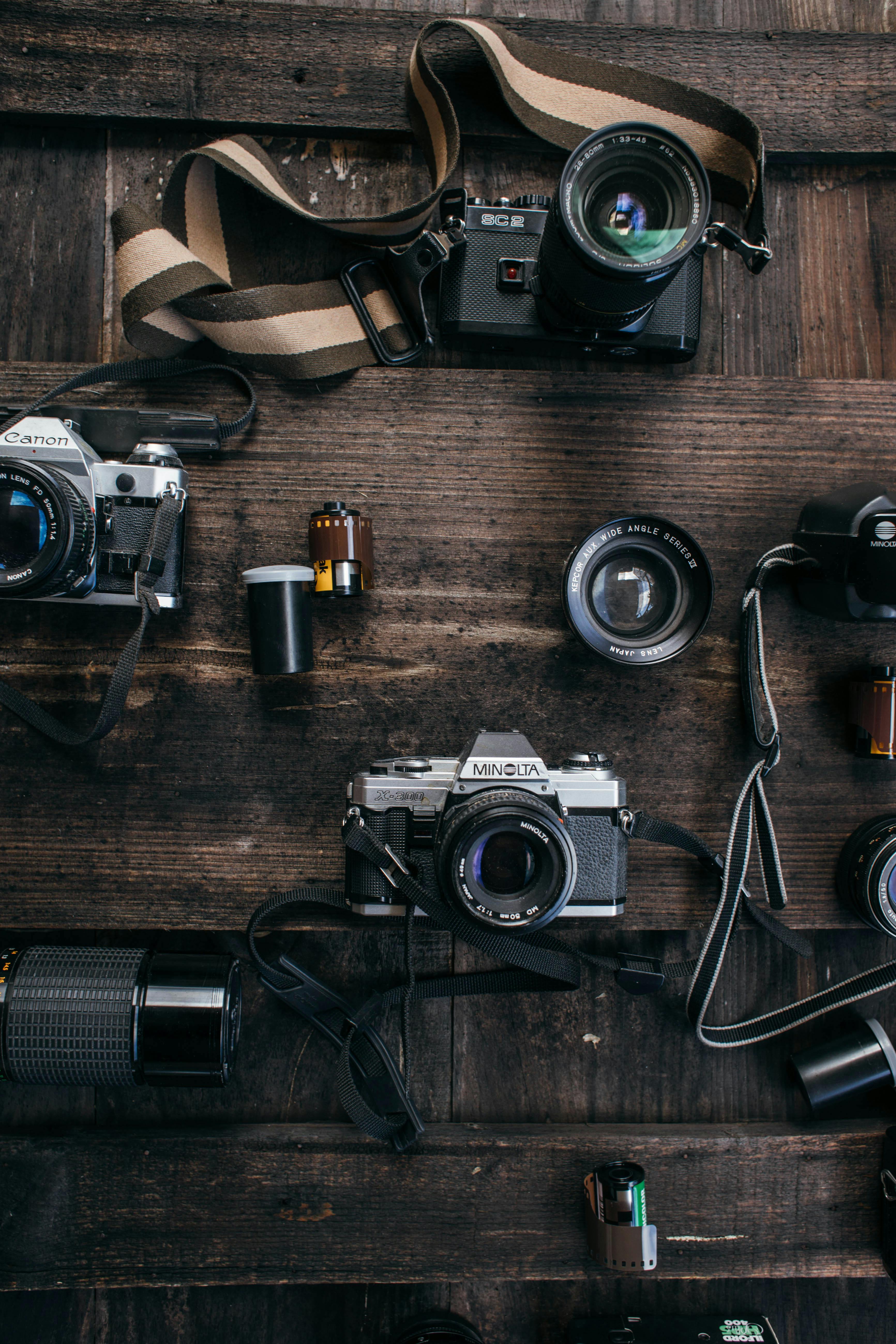 set of retro cameras on wooden table