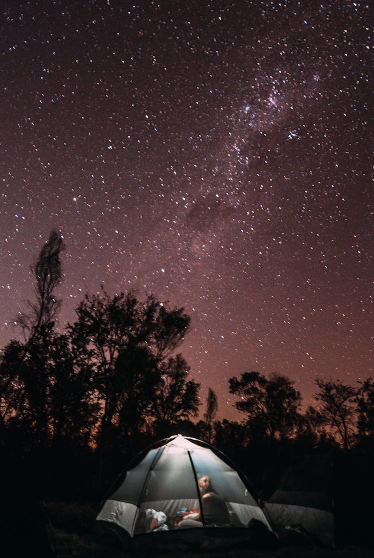 Anonymous Camper In Tent Against Starry Sky