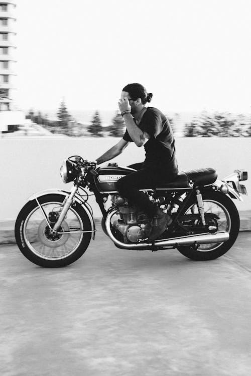 Free Unrecognizable male biker riding motorcycle on asphalt road Stock Photo