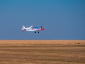 White and Red Airplane in Mid Air