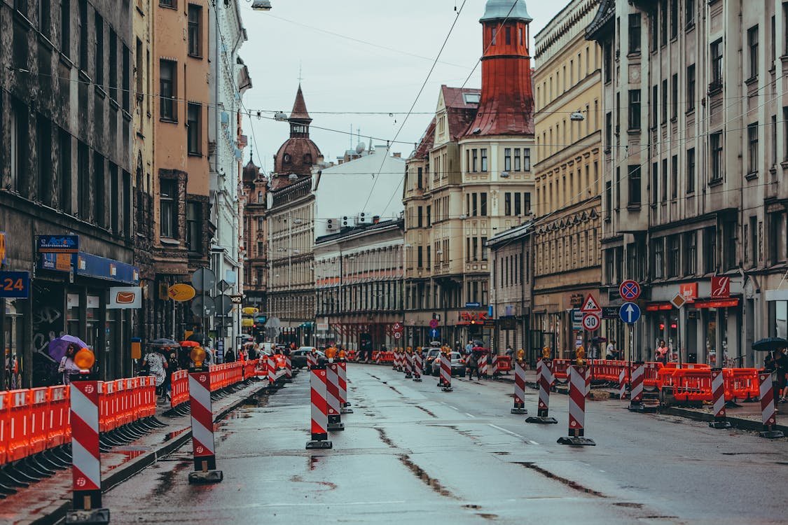 Free Wet road with signal posts in residential area Stock Photo
