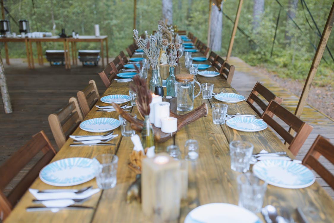 Free Brown Wooden Table With Chairs and Plates Stock Photo