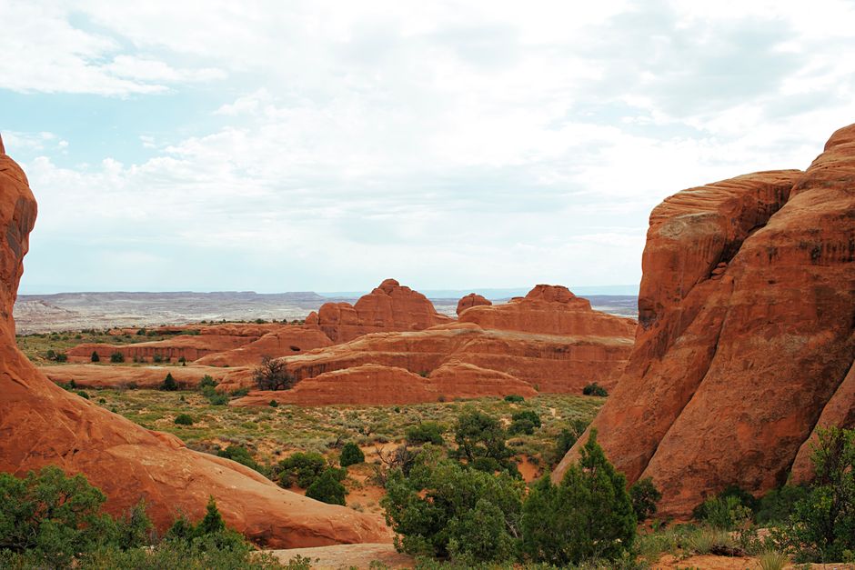 Explore stunning red rock formations and arches in Utah's desert landscape, perfect for nature photography.