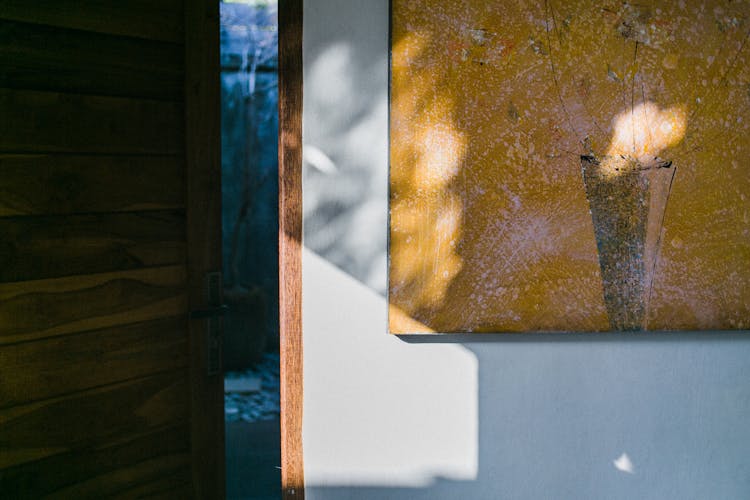 Door And Shabby Picture On Wall In Sunlight