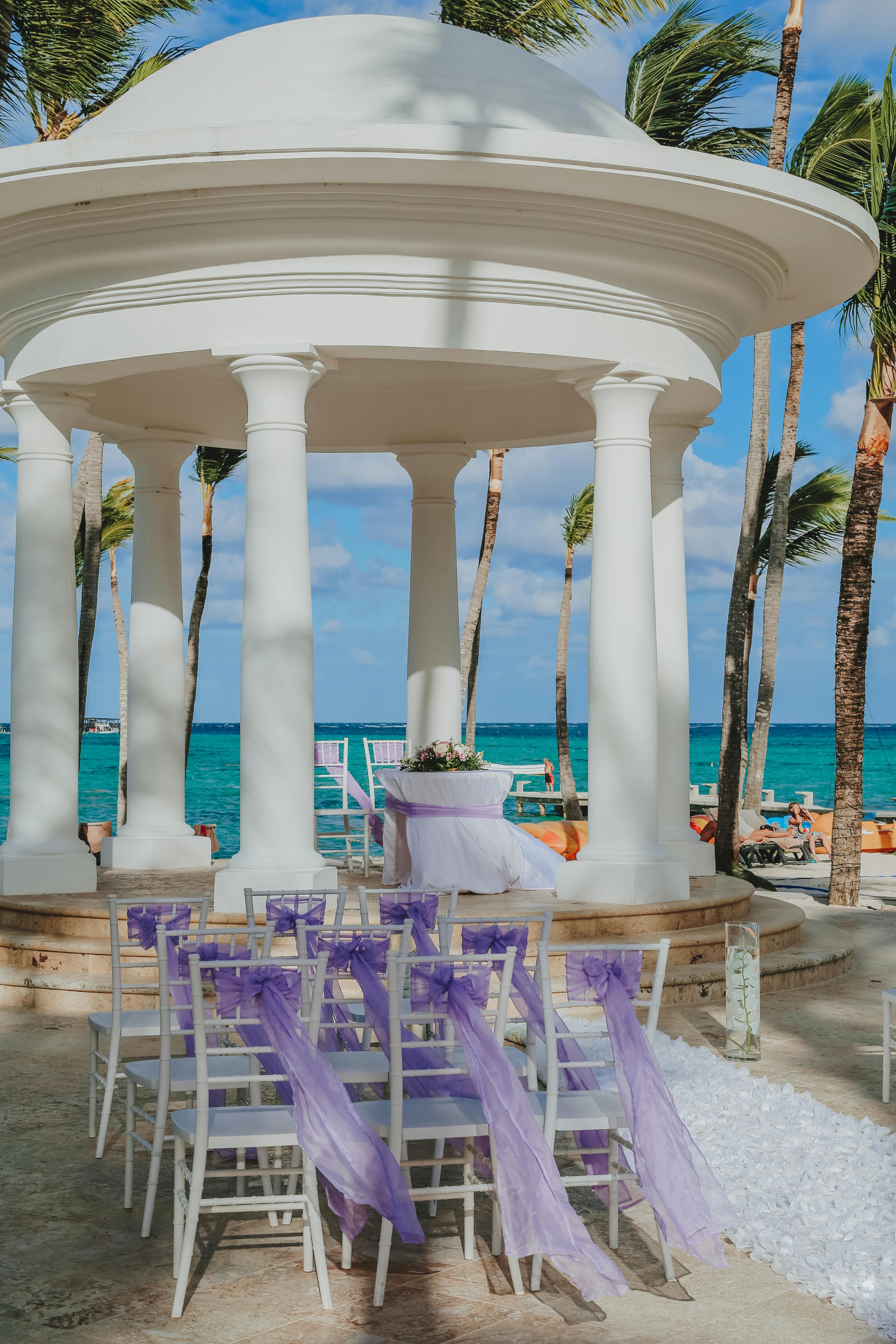 Pavilion with decorated furniture near ocean on wedding day · Free