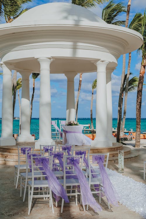 Pavilion with decorated furniture near ocean on wedding day