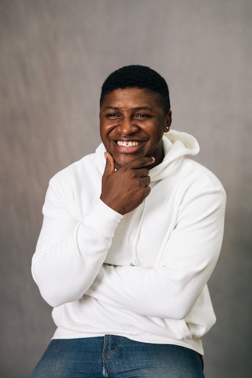 Free Photo of a Man in a White Hoodie Smiling Stock Photo