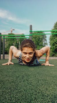 Woman with tattoos exercises in a park, illustrating a healthy lifestyle and fitness.