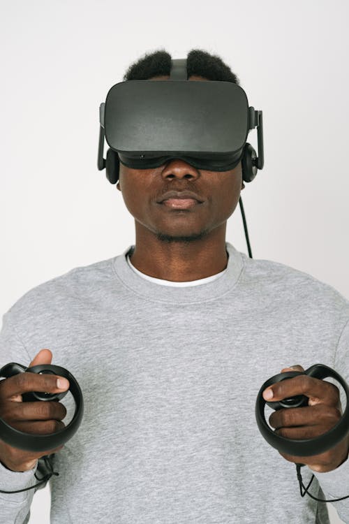 Free A Man in Gray Sweater Enjoying the VR Headset he is Playing Stock Photo