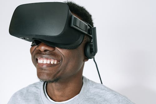 Free A Happy Man in Gray Sweater Wearing VR Glasses Stock Photo