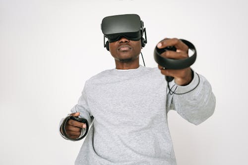 Free Man in Gray Sweater Wearing Black VR Headset Stock Photo