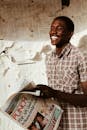 Happy black man with newspaper in hand