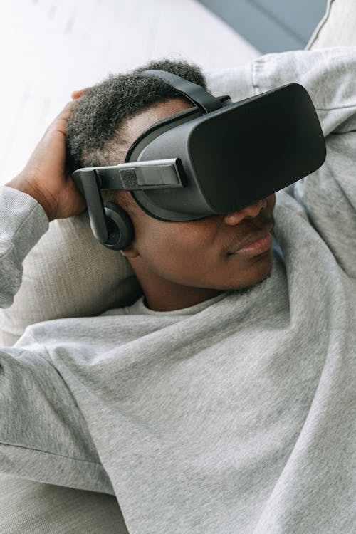Man in Gray Sweater Using a Virtual Reality Headset