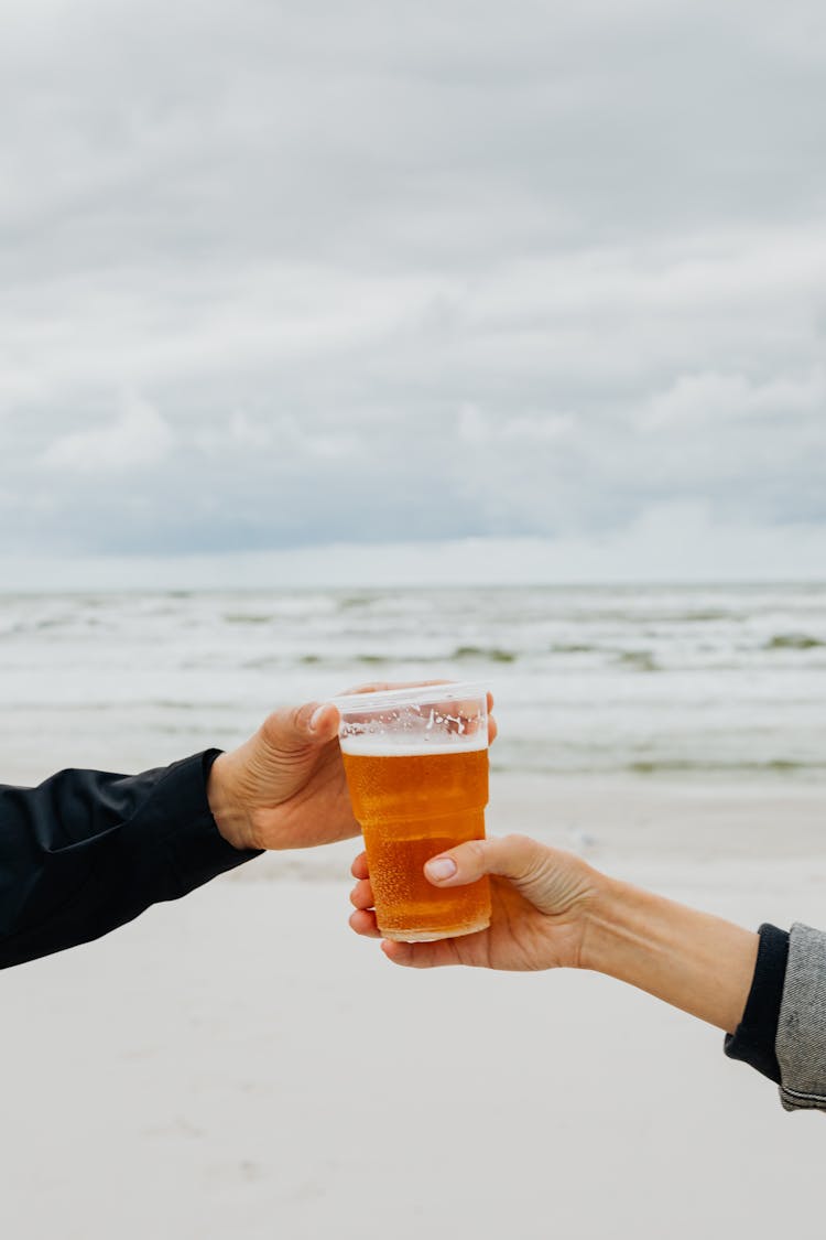 Hands Holding Glass Of Beer