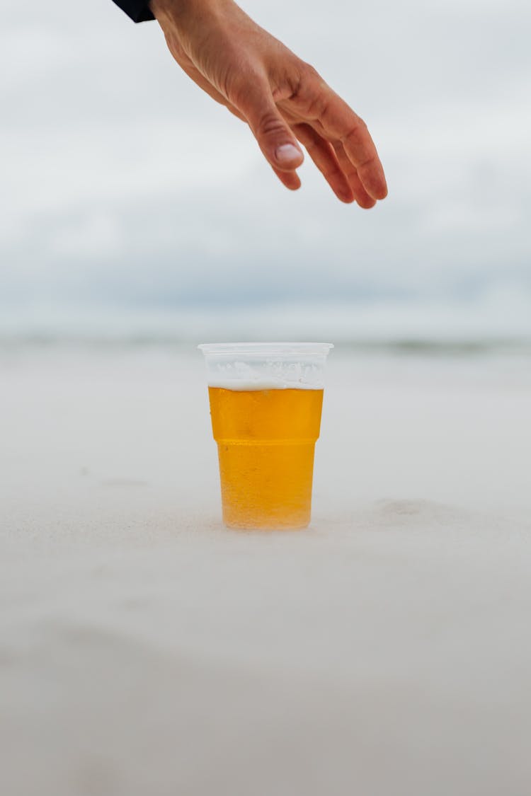 Hand Reaching For A Glass Of Beer