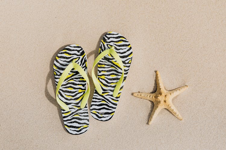 Flip Flops And A Starfish On Sand