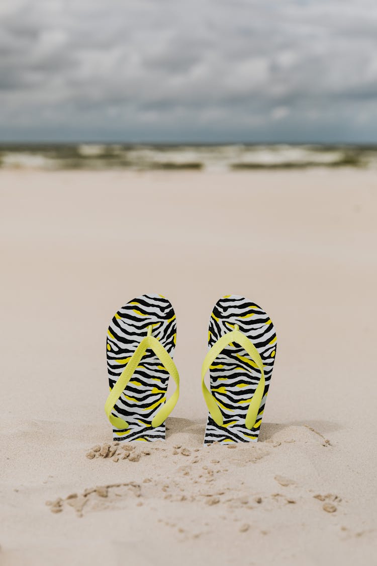 A Pair Of Flip Flops On The Sand