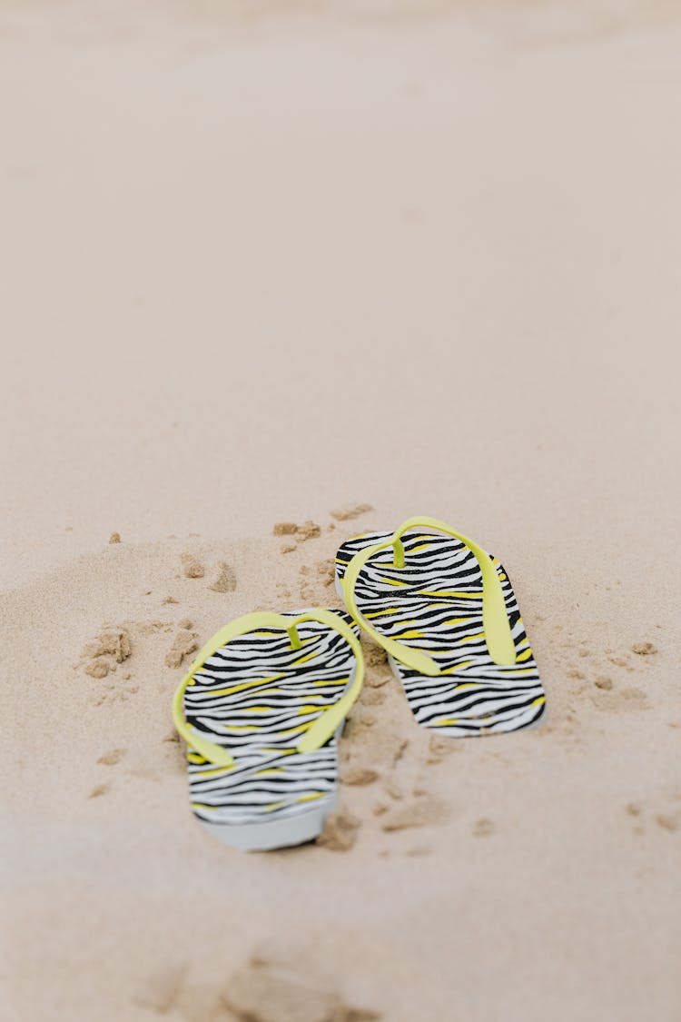 A Pair Of Flip Flops On The Sand