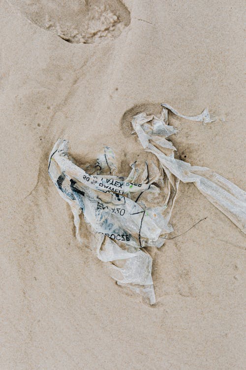 Free Plastic Waste on Beach Sand Stock Photo