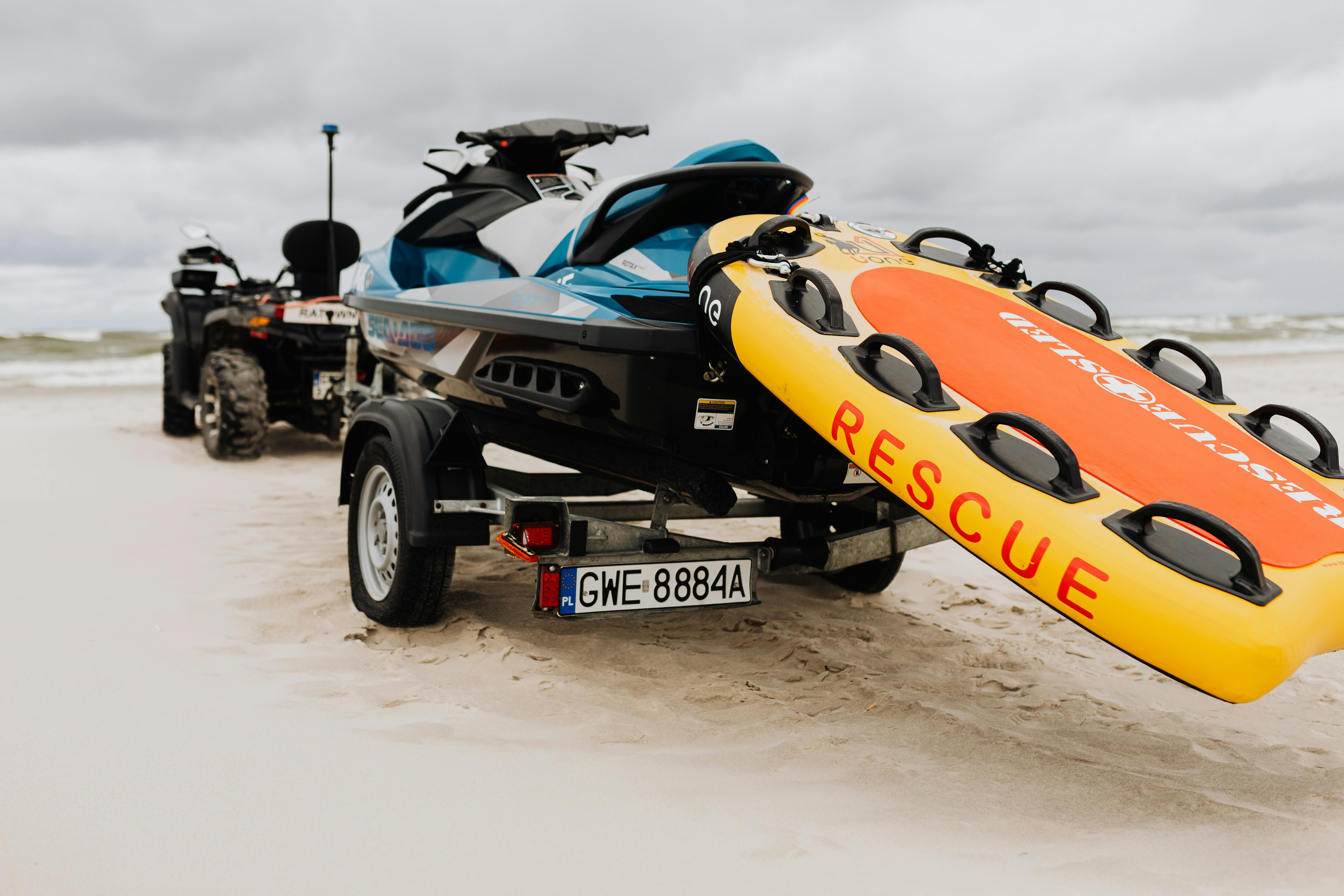 Prescription Goggle Inserts - Jet ski and rescue float ready for emergency on a sandy beach under cloudy skies.