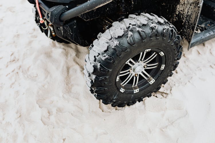 Black Rubber Tire On Beach Sand