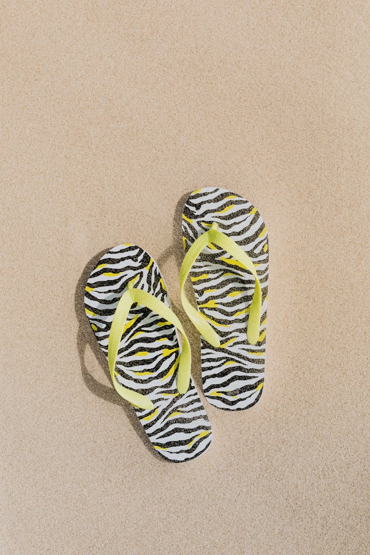 A Pair Of Flip Flops On The Sand