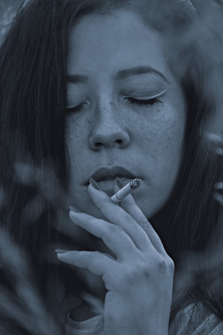 Woman Smoking Cigarette In Blue Color