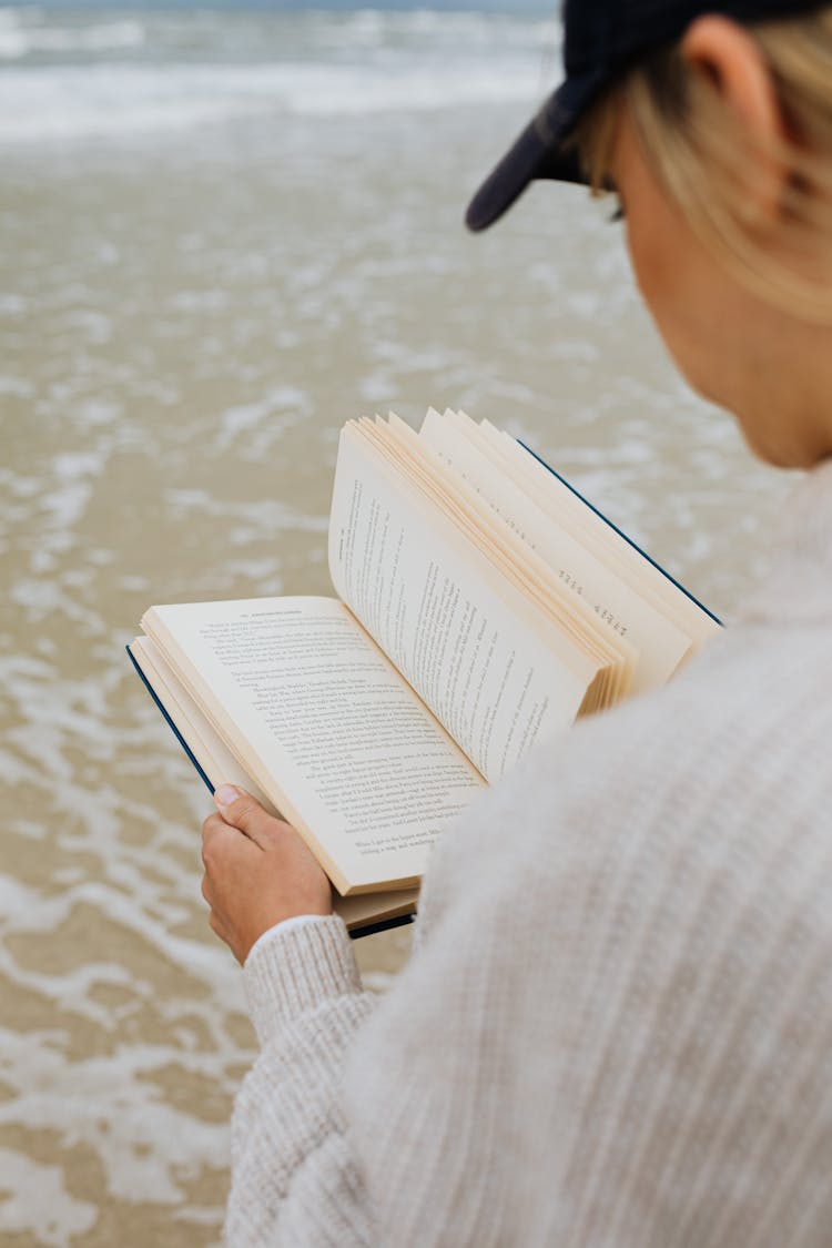 Person Reading Book On Beach