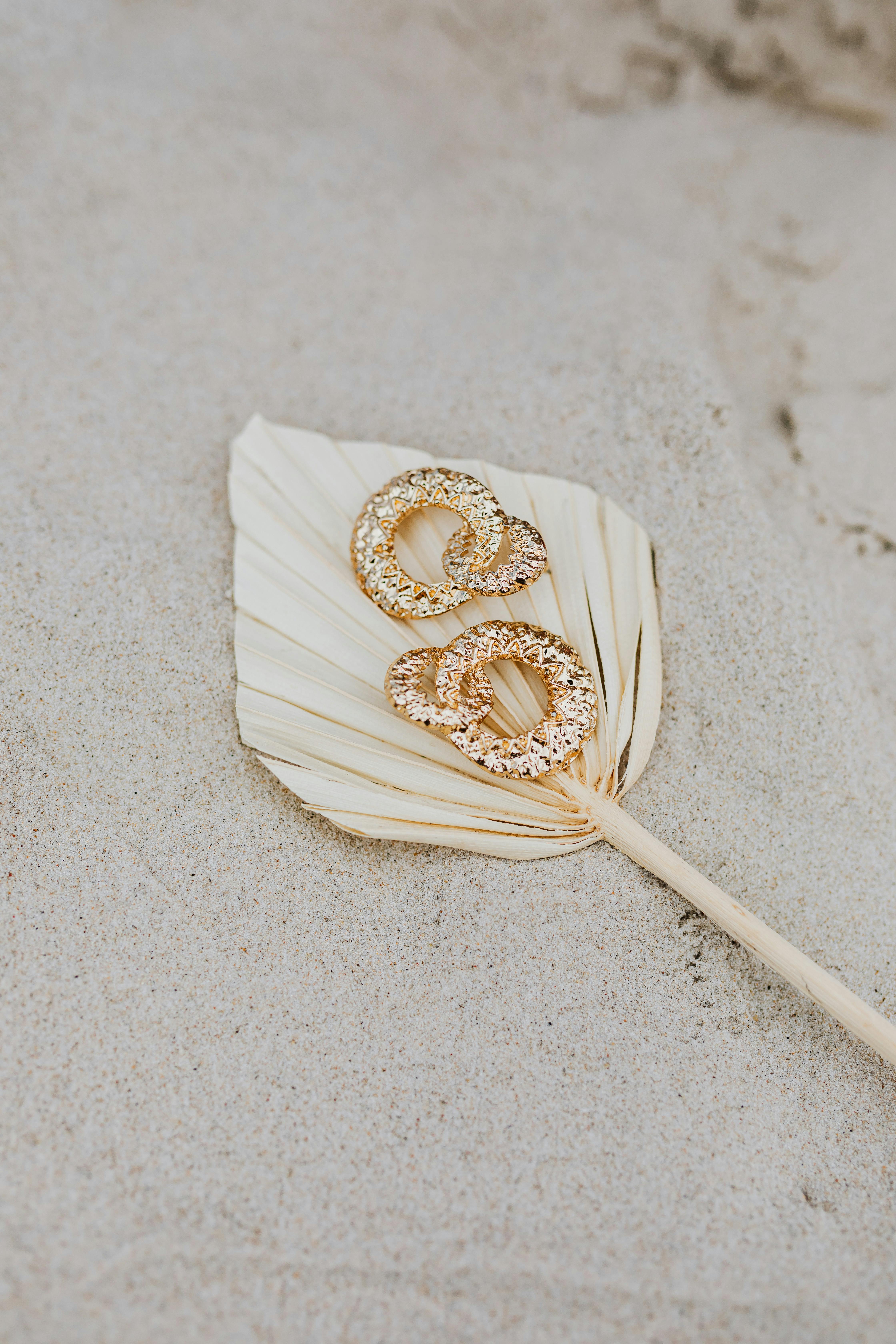 gold jewelry on the sandy shore