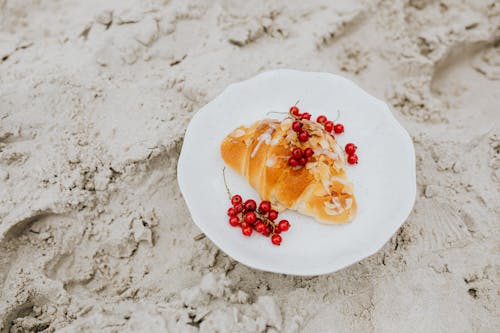 Croissant and Currants on White Ceramic Plate 