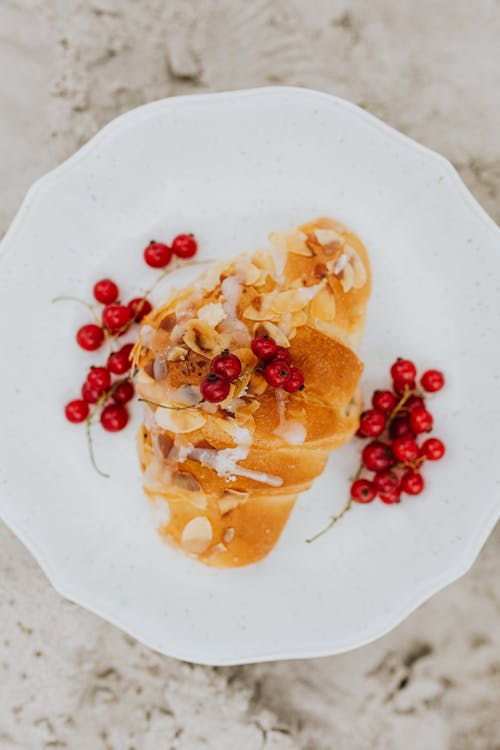 Croissant and Currants on White Ceramic Plate 