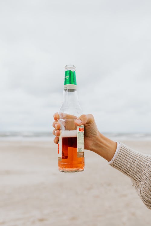 Person Holding Beer Bottle