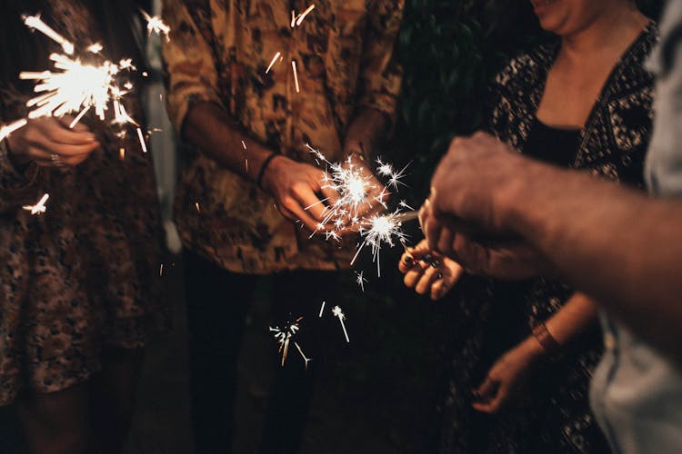 Group Of People With Sparkling Bengal Lights