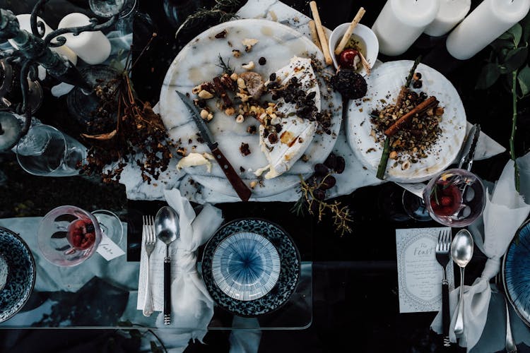 Banquet Table With Served Food And Cutlery