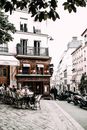People sitting at tables in street cafe