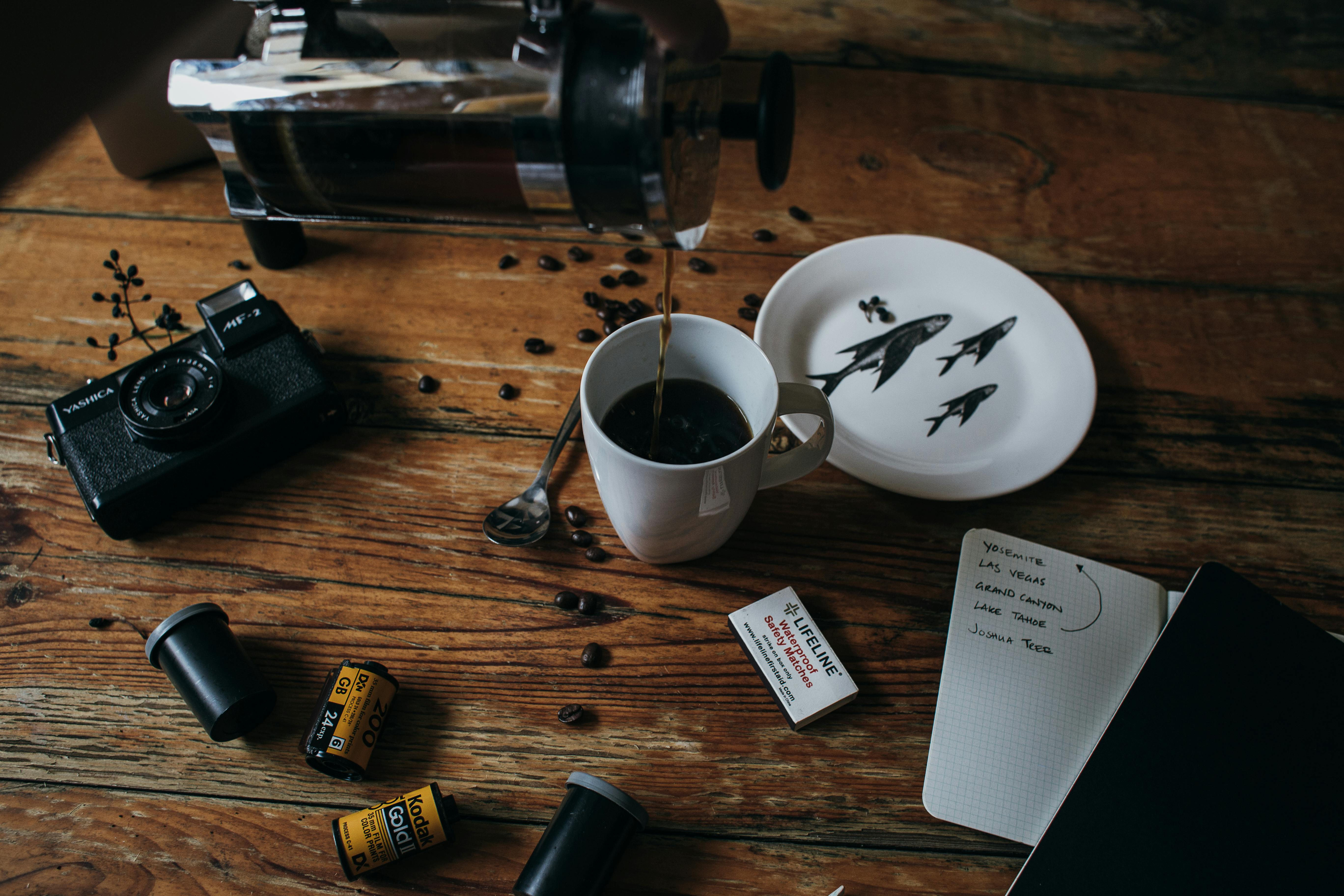 coffee pouring in cup placed on messy table