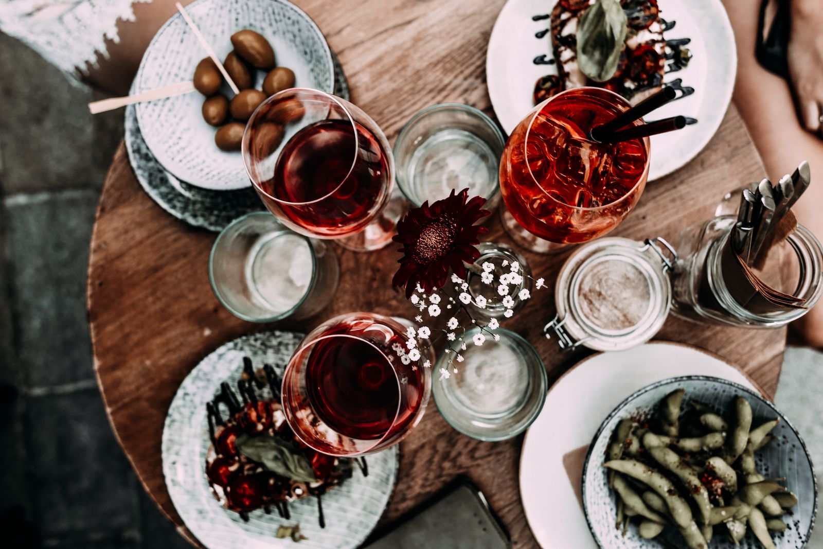 A table set with glasses and small plates in golden evening light