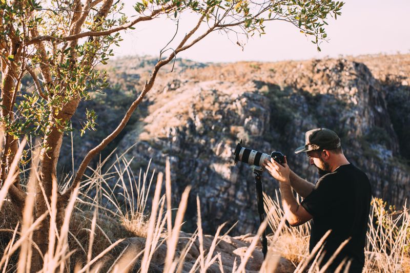 Photographer among sunlit stone hills — Rachel Claire on Pexels