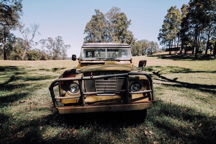 Grunge Abandoned Car Left On Grassy Meadow