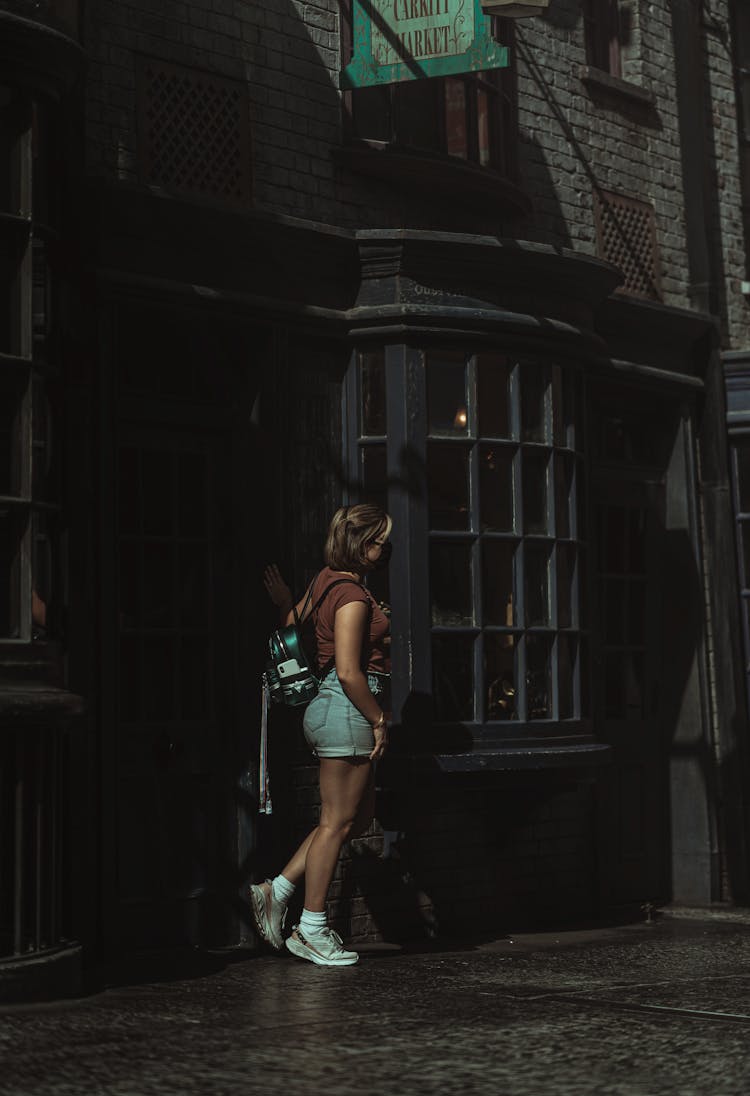 Stylish Woman Standing Near Old Building