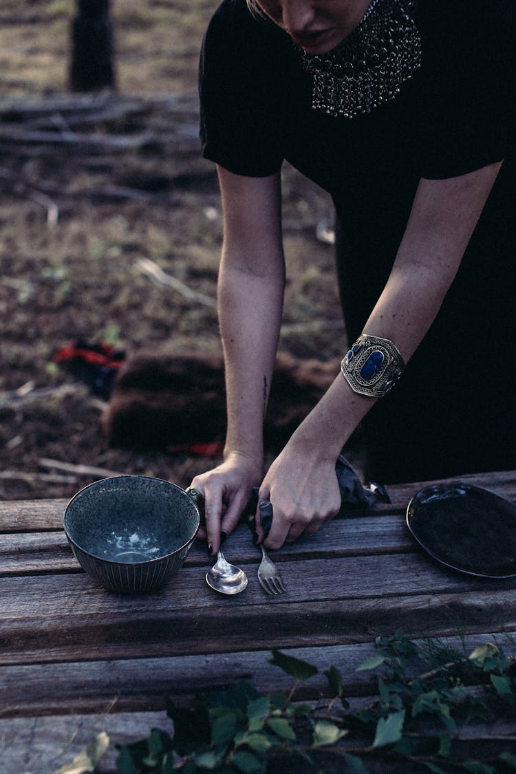 Crop Woman Setting Table In Forest