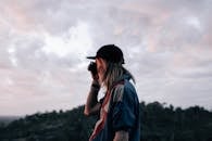 Unrecognizable person taking photo in evening nature