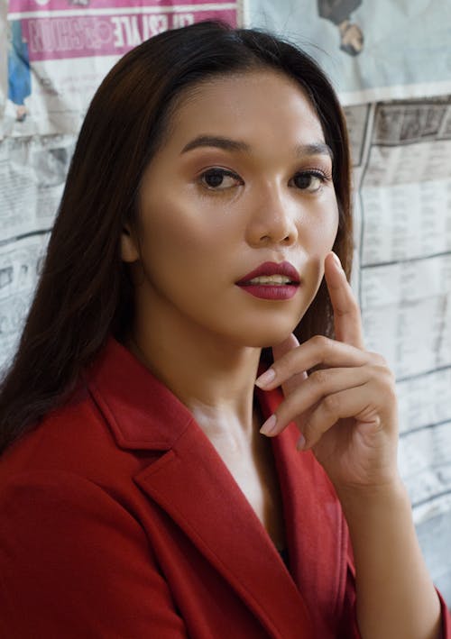 Free Portrait of a Beautiful Woman in a Red Blazer with Red Lipstick  Stock Photo