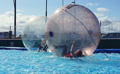 Children Inside the Water Ball on the Pool